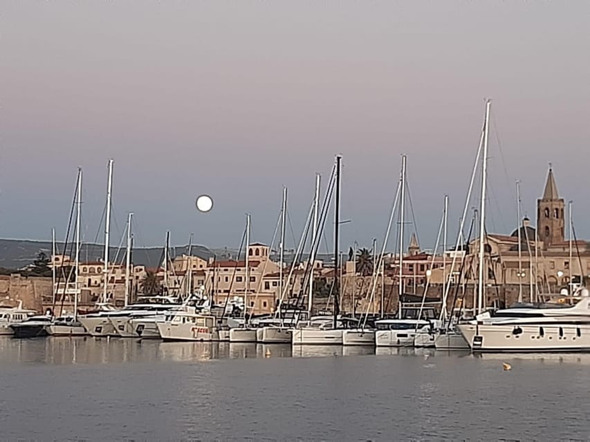 Alghero catamaran sunset tour Alghero - The first sail: seeing Alghero’s old walls from the water