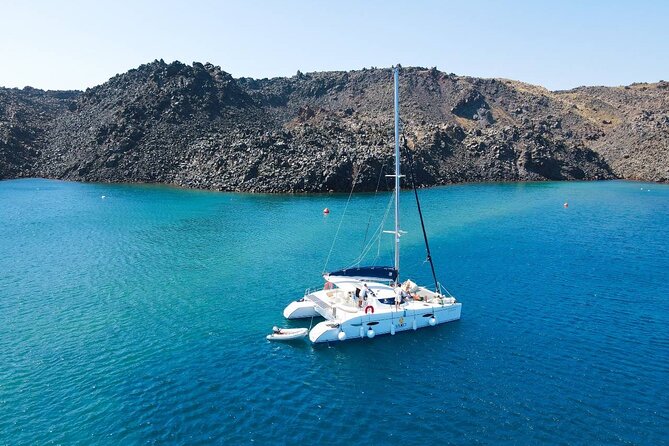 Best of Santorini Private Half-Day Catamaran Cruise with transfer and meal - Old lighthouse and Black Rock: where photos become the point