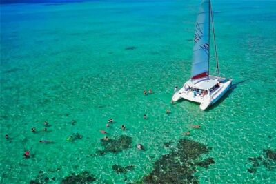 Catamaran to Ile aux Cerf with Parasailing, Tube Riding & Lunch - Ile aux Cerfs cruise time: the boat vibe and the meal setup