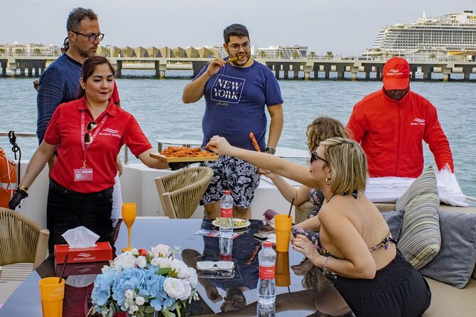 Dubai Harbour Super Yacht Experience with gourmet & Drinks - The party setup: live DJ, sparkling drinks, and deck energy