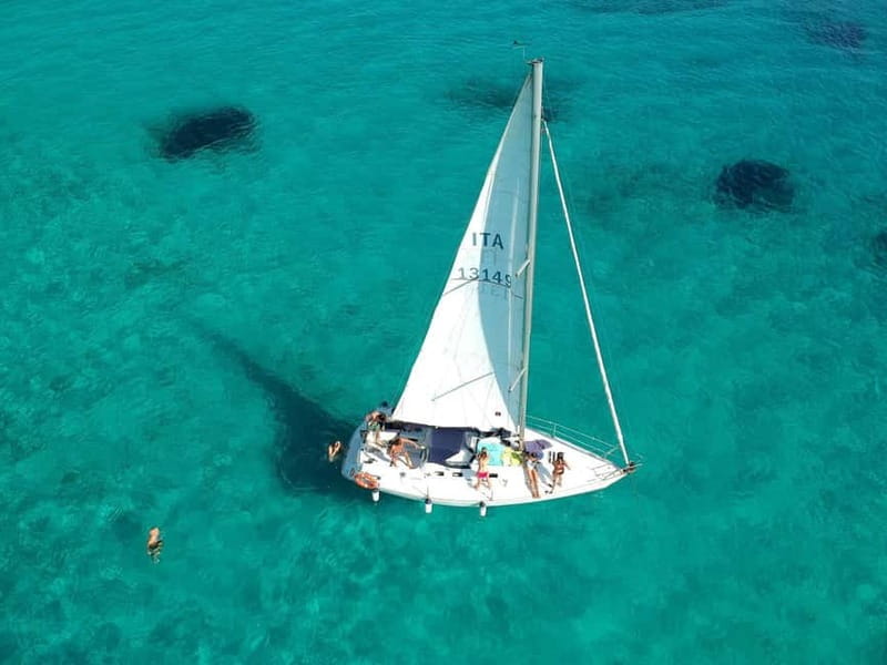 From Stintino: Half-Day Sailing Boat Tour to La Pelosa - Meeting Diavola by the fuel station and getting comfortable fast