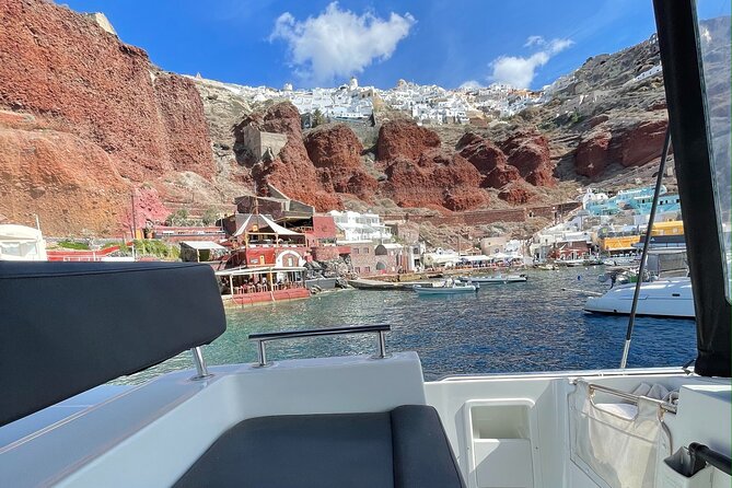 Half Day Premium Catamaran Cruise in Santorini including Oia - Oia from the water: Amoudi Bay timing and the Venetian lighthouse view