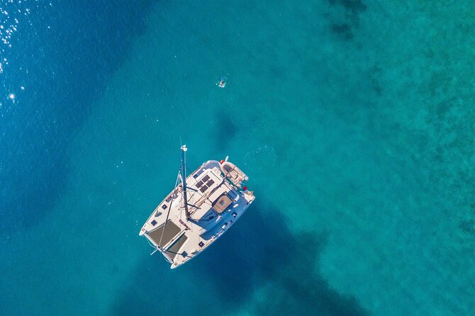 Mykonos: Private Catamaran Cruise—Hotel Pickup, BBQ & Drinks - Mykonos, Delos, and Rhenia from a catamaran angle