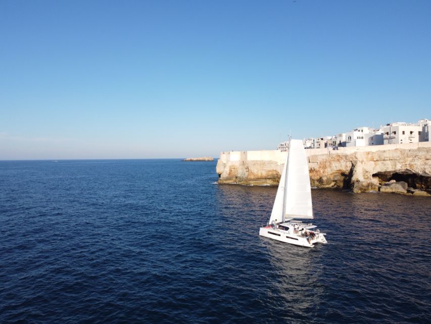 Polignano a Mare: Catamaran Tour with Aperitif & Local Food - Grotta Palazzese: a quick pause with big visual payoff