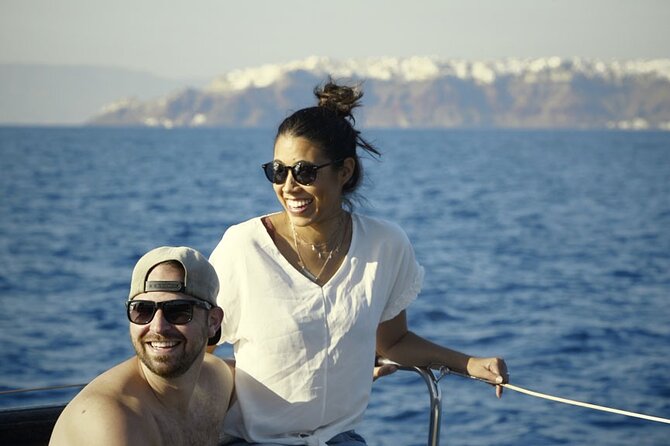 Private Luxury Santorini Catamaran Cruise with Port Pickup - Stop 1: Red Beach swimming with red volcanic sand
