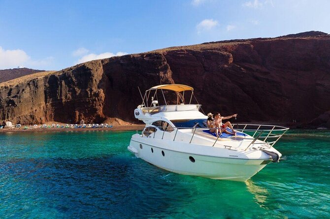 Private Motor Yacht Cruise with BBQ, Open Bar & Transfers - The Caldera cruising part: caves, the Venetian Lighthouse, and cliff views