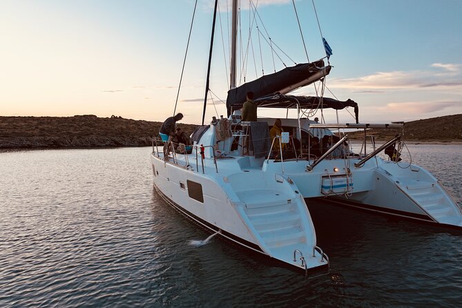 Private Mykonos Catamaran Day Cruise with Meals & Water Toys - Rineia: calmer water, snorkeling time, and boat-only coves