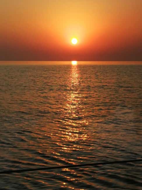 Rhodes: Sunset Catamaran Cruise with Snack, Fruits & Drinks - Kalithea Springs Bay: Your Hour to Swim, Snorkel, and Paddle