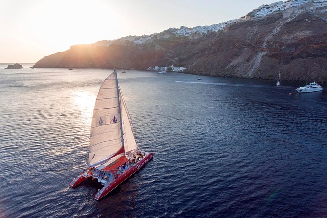 Sailing Catamaran Cruise in Santorini with BBQ, Drinks and Transfer - Food and drinks on board: included wine, simple BBQ, and what’s not included