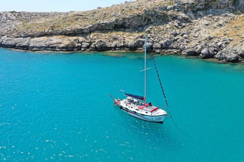 Sailing tour around Lindos with food and drinks - Getting onboard at the big jetty near Pallas Beach