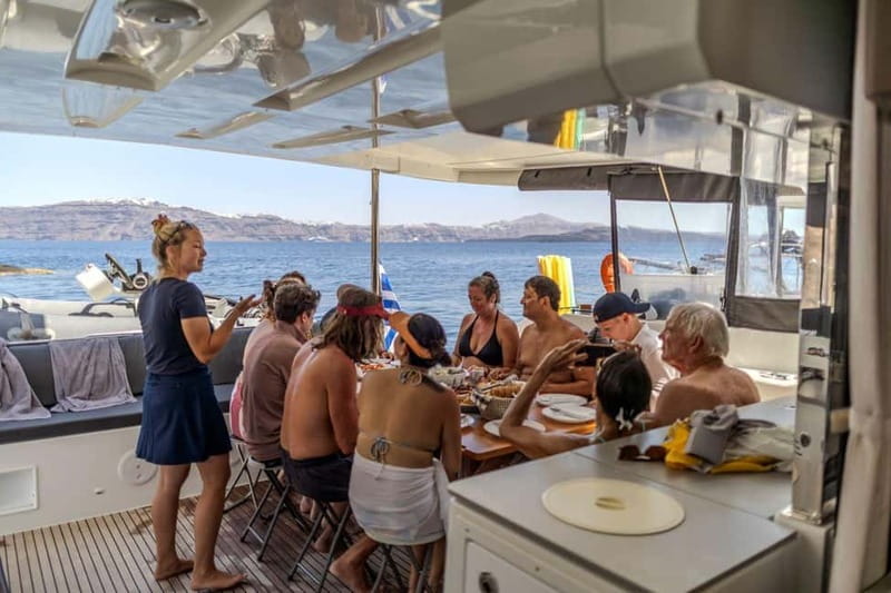 Santorini: Catamaran Cruise with Fresh Meal & Open Bar - Santorini Volcano photo stop and the “snorkel-with-goggles” setup