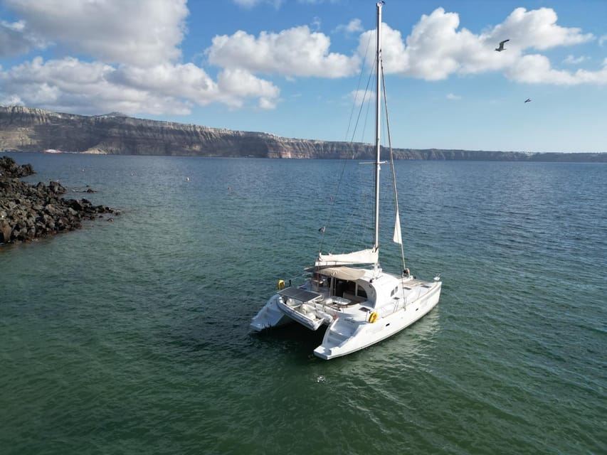 Santorini: Catamaran Cruise with Greek BBQ and Drinks - Getting There: Hotel Pickup vs Meeting at Vlychada Marina