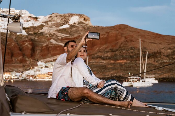 Santorini Catamaran Cruise with Greek Meal, Open-Bar and Sunset - Red Beach Swim Break: Offshore Anchoring, Simple Snorkel Options