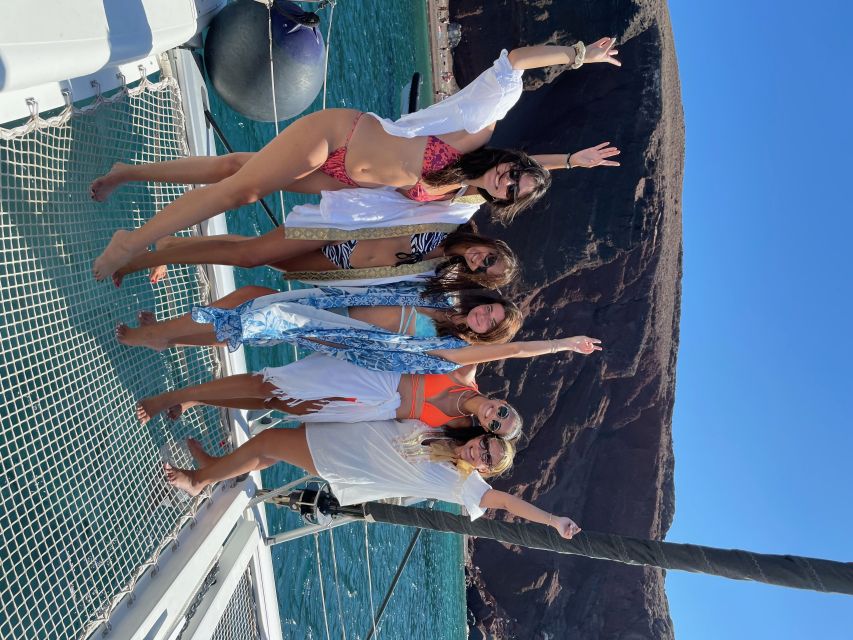 Santorini: Catamaran Cruise with Meal & Open Bar - Red Beach and White Beach: volcanic color, quick guided stops, then water