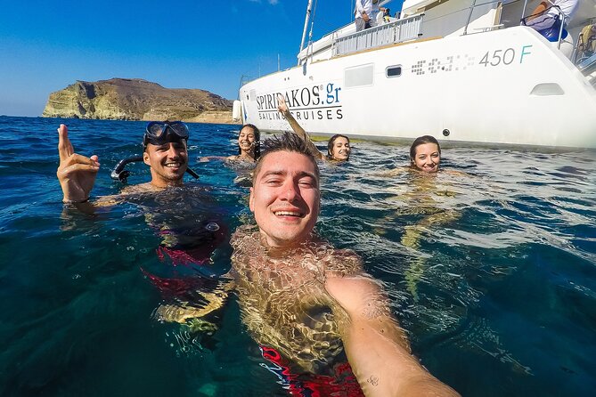 Santorini Classic Catamaran Cruise with BBQ, Drinks and Transfers - Mesa Pigadia swim stop: snorkeling gear and a relaxed sundeck break