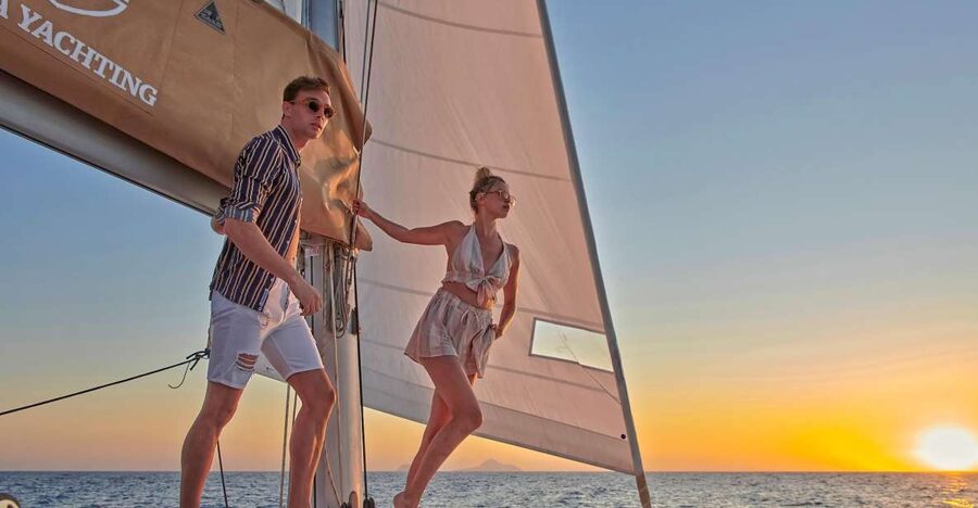 Santorini Gold Catamaran Cruise with Snorkel, BBQ & Open Bar - Stop 1: Red Beach swimming and snorkeling in iconic cliffs