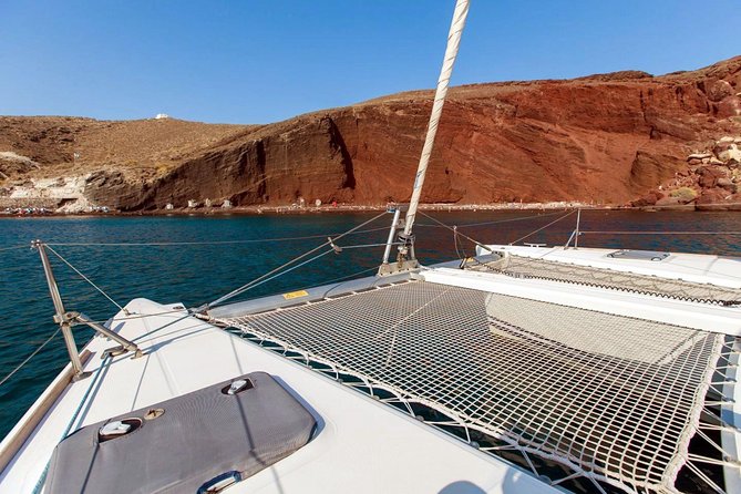 Santorini Half Day Catamaran Private Cruise incl. Meal, Drinks & Free Transport - Red Beach and White Beach: volcanic color, short stops, and real snorkeling payoff