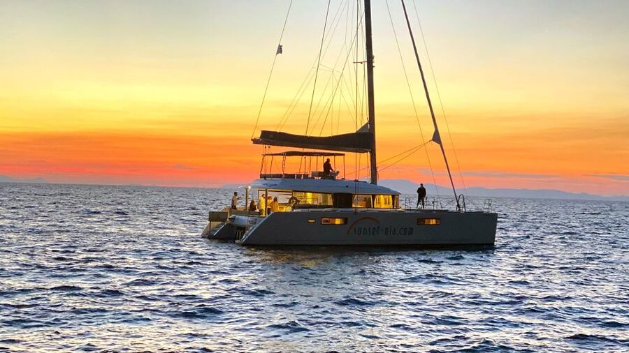 Santorini: Luxurious Catamaran Cruise with Meal & Open Bar - Wind, choppy water, and what to pack so you still enjoy it