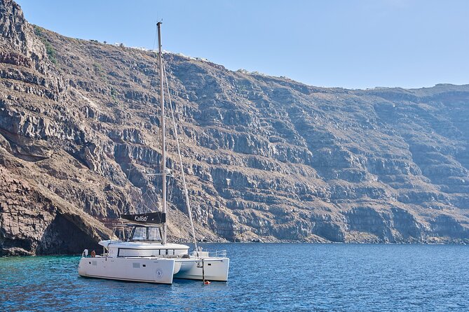 Santorini: Luxury Catamaran Cruise with Fresh Fish BBQ & Drinks - Red Beach and the Red-to-White Color Shift: The Volcanic Postcard Stop