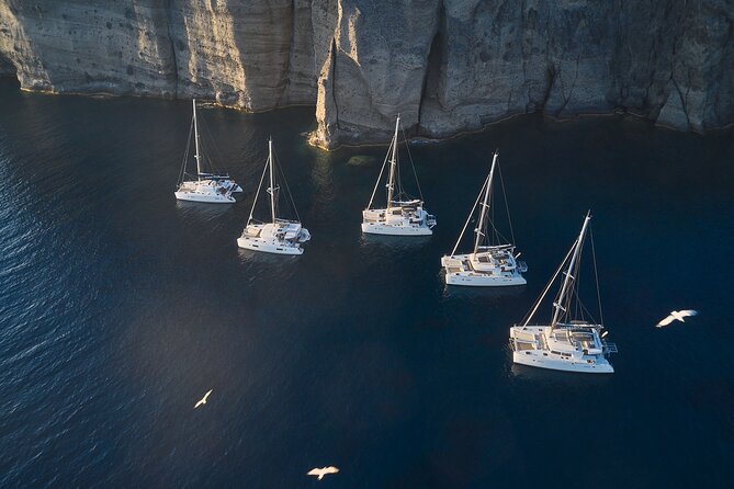 Santorini: Luxury Catamaran Cruise with Fresh Fish BBQ & Drinks - Getting There and What to Expect With Pickup