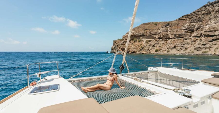 Santorini: Luxury Catamaran Day Trip with Meal and Open Bar - Getting on Board: Hotel Pickup and the First 30 Minutes