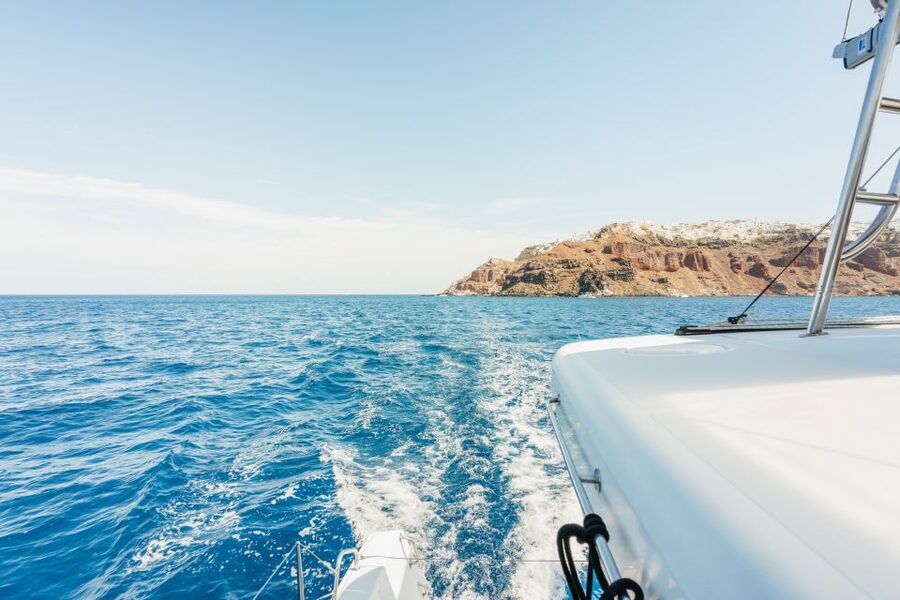 Santorini: Luxury Catamaran Day Trip with Meal and Open Bar - Greek Meal on Board: Dolmadakia, Skewers, and the Open Bar Match