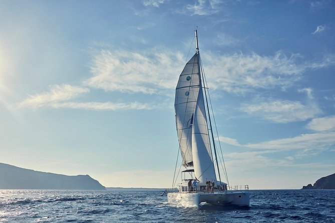 Santorini Sunset Luxury Sailing Catamaran Cruise with BBQ, drinks, transfer - Ancient Lighthouse From the Sea: Why the Timing Works