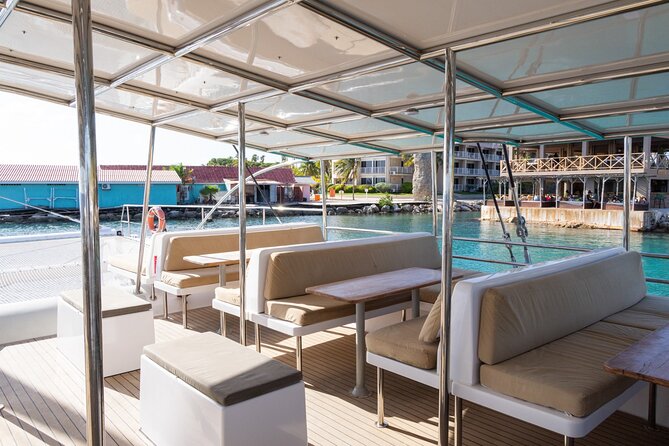 Sunset Sailing Cruise with premium drinks and bites - The catamaran vibe: nets, shade, and music after dark
